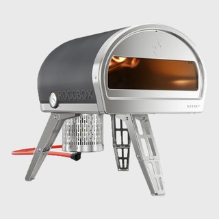 roccbox pizza oven with flame inside and red gas hose behind