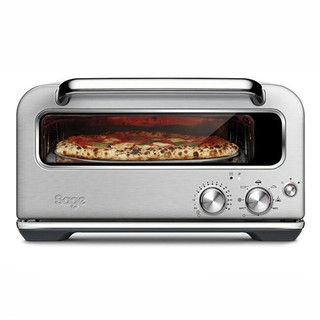 silver pizzaiolo pizza oven with pizza cooking inside