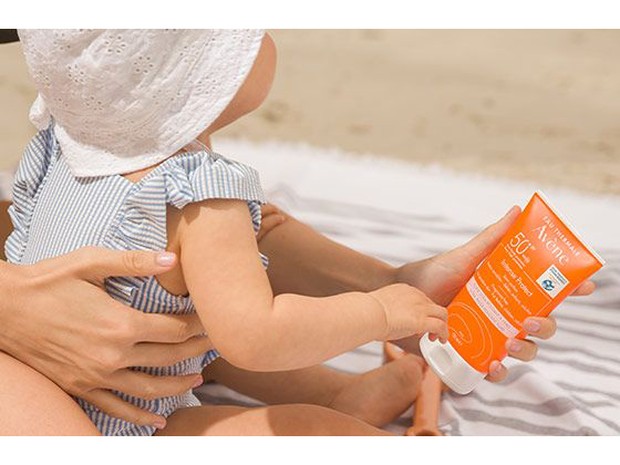 Baby using Avene sunscreen.