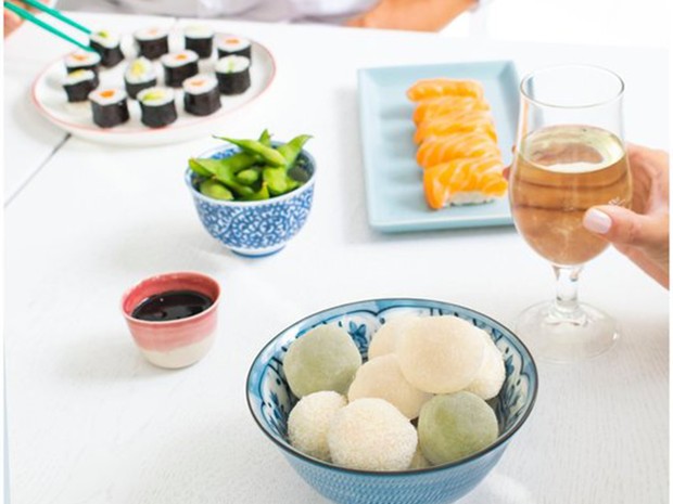 green-and-white-mochi-on-dinner-table-with-wine-and-sushi