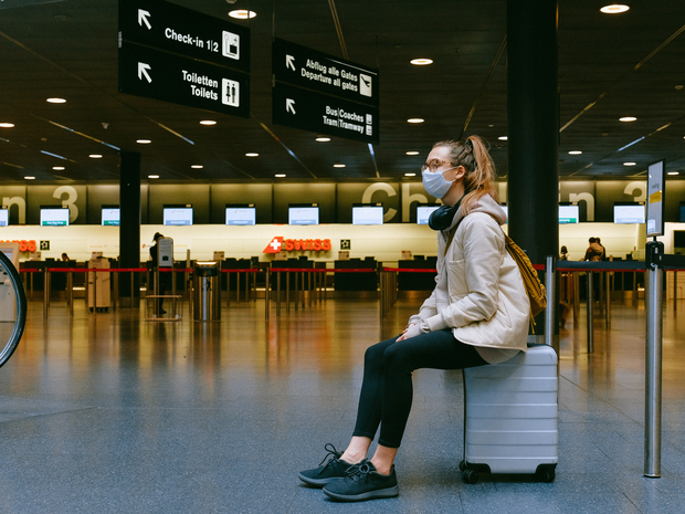 how-to-find-travel-insurance-woman-sitting-on-suitcase