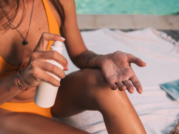 Woman using sunscreen.