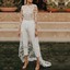 woman wearing white cropped jumpsuit with floral train